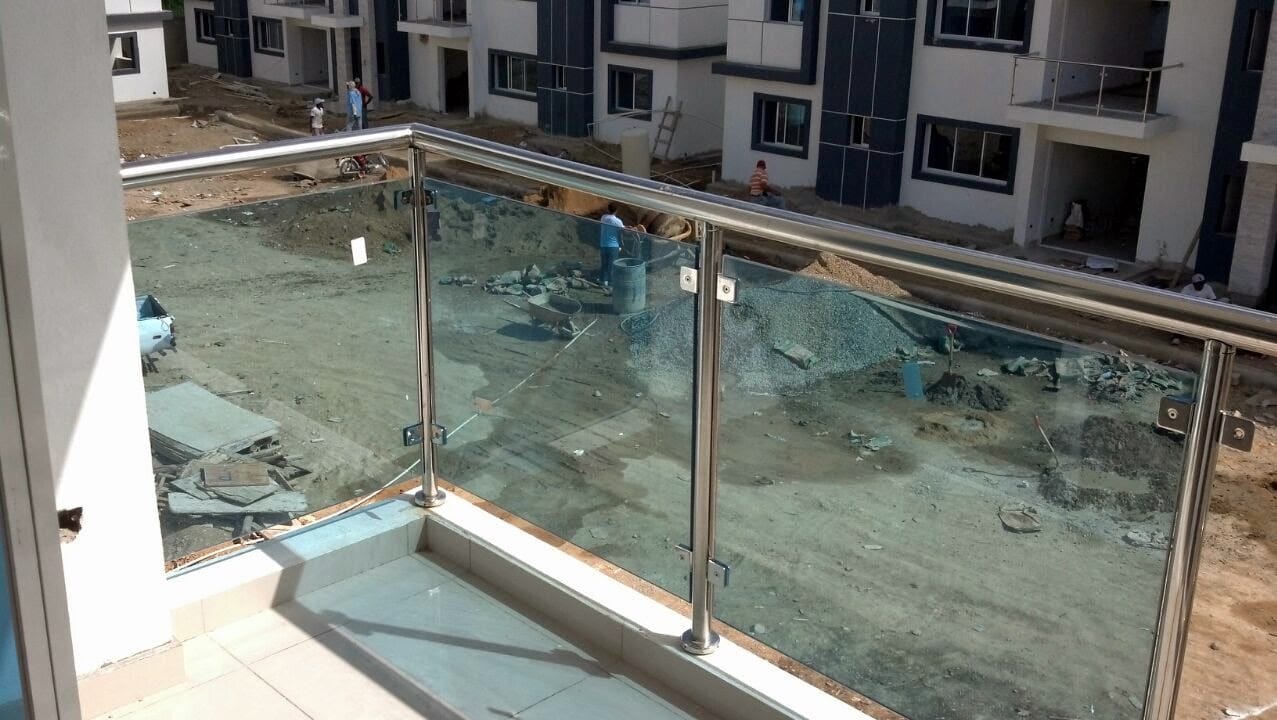 Instalación de baranda de vidrio en balcón en proceso de construcción